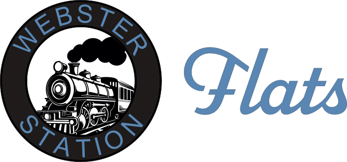 A logo with a train and the words "Webster Station" and "Flat" written in cursive.